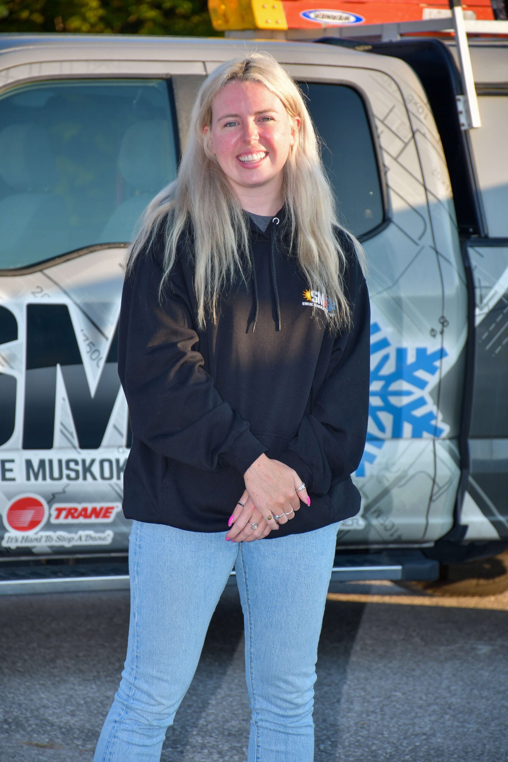 team member in front of fleet vehicle